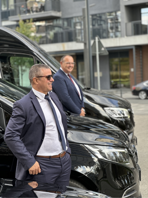Workers in front of their vehicles